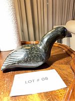 Left side view of soapstone bird showing feather carving and overall form