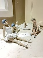 All four ballerina figurines grouped on countertop