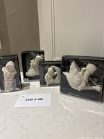 Four boxed Snowbabies ornaments front view