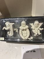 Boxed set showing all three JOY ornaments through lid