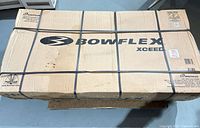 Top view of strapped Bowflex Xceed box on pallet