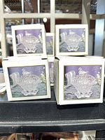 Stacked white retail boxes displaying product image of crystal lidded dish