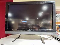 Front view of Insignia 32" TV on stand