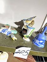 All four porcelain items on shelf showing relative sizes