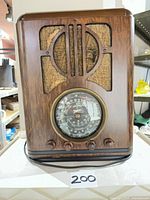 Front view showing full wood cabinet, speaker grille, dial and knobs