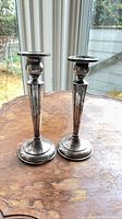 Both Birks sterling candlesticks standing on table