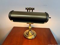 Full view of brass lamp on table