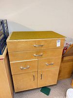 Front view of cabinet showing drawers, doors, casters