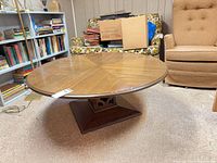 Full view of round wood coffee table showing top pattern and pedestal base