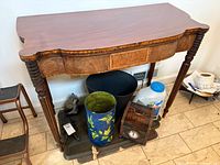 Front view of Federal style hall/game table showing serpentine top, burled apron, spiral legs