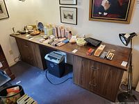 Full view of long four-drawer woodgrain file cabinet placed against wall