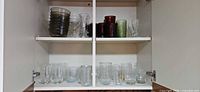 Cabinet shelves showing all glassware pieces