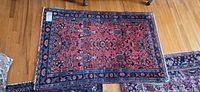 Full top view of red and blue floral rug