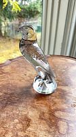 Profile view of Lalique clear crystal falcon on base