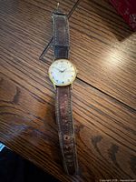 Front view of Birks wristwatch showing dial, case and worn leather strap