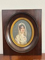 Front view of framed miniature portrait in dark wood frame