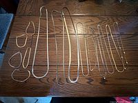 All necklaces and bracelets arranged on wooden surface