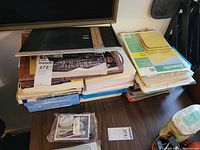 Overall view of stacked office paper, folders, envelopes on desk