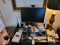 Overview showing HP monitor, Edifier speakers, boxed accessories, cassette recorder, cables