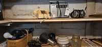 Overview of shelf showing phone, radio, headphones, light fixtures and bulbs