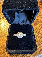 Ring in presentation box showing top view of diamond and setting