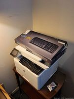 HP LaserJet Pro printer with boxed Matias Quiet Pro keyboard resting on top