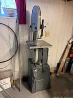 Full front view of Rockwell band saw showing table, upper wheel guard, and stand