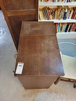 Closed wood cabinet top with lot sticker visible