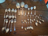 All 31 sterling spoons laid out by type