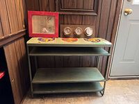 Overall view of shelf unit with mirror and barometer on top