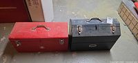 Red Viking and black Mastercraft toolboxes closed