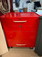 Front view of closed red Beach tool chest showing two visible drawers and brand badge