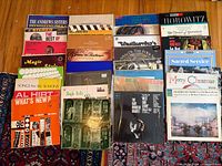 Overview of approximately 23 LP records laid out on floor showing cover art