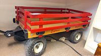 Full view of wood wagon with red rails and tires