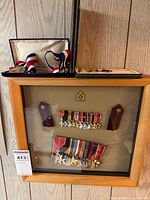 Front view of shadow box showing all medals, ribbons, epaulettes, badge and glider award case