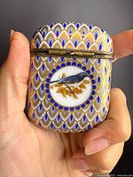 Front view showing enamel pattern, bird medallion and bronze hinge