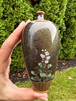 Front view of Japanese cloisonné bottle vase showing floral design and spiral ground