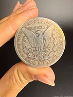 Reverse of 1890 Morgan silver dollar showing eagle, denomination, legends