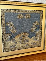 Close view of silk rank badge showing cloud and wave embroidery