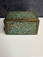 Front view showing turquoise mosaic and brass frame