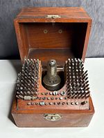 overall view of open wooden box with staking tool and stakes