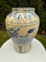 Front view of porcelain jar showing mythical creature and wave design