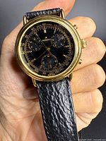 Front view showing dial, chronograph sub-dials and gold-tone case