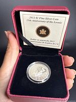 Coin in open RCM presentation case with insert card visible