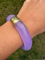 Full bracelet on wrist showing lavender jadeite and gold-tone clasp
