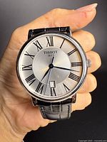 Front view showing dial, brand, Roman numerals and date window