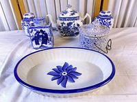 group view of five blue and white pieces including teapot, two jars, oval bowl, speckled canister