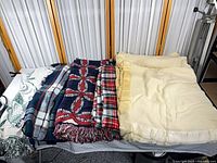 All five blankets laid out side by side on a table