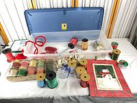 Overall view of container, ribbon spools, bead garlands, bows and cards