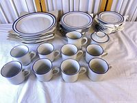 full set showing plates, mugs, creamer and sugar bowl